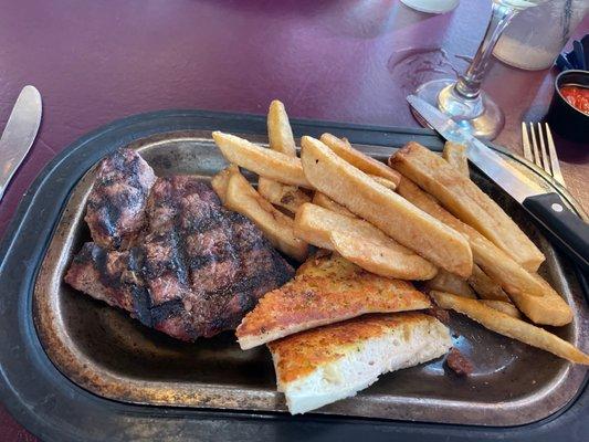 Sizzler steak with fries.