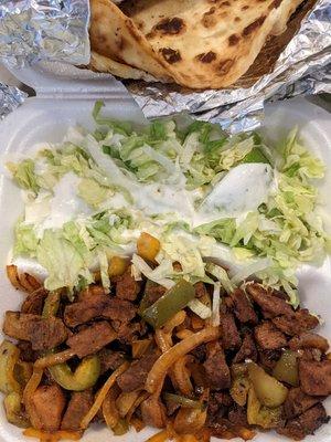 Suqaar & Ceeysh.  Beef sauté with two massive pieces of pan bread.