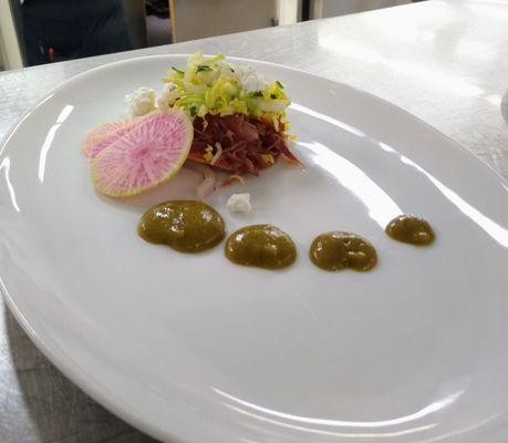 Duck confit tostada with napa slaw, salsa verde, watermelon radish