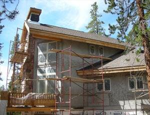 Prepping a large home for one of our exterior finishing and painting projects.