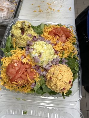 Our Trio salad with extra cheddar cheese and some red onions!