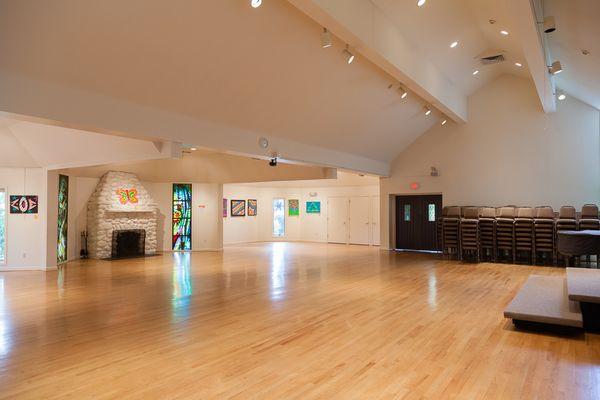 Anderson Auditorium is a beautiful, spacious room with several stained glass windows, vaulted ceiling and AV equipment.