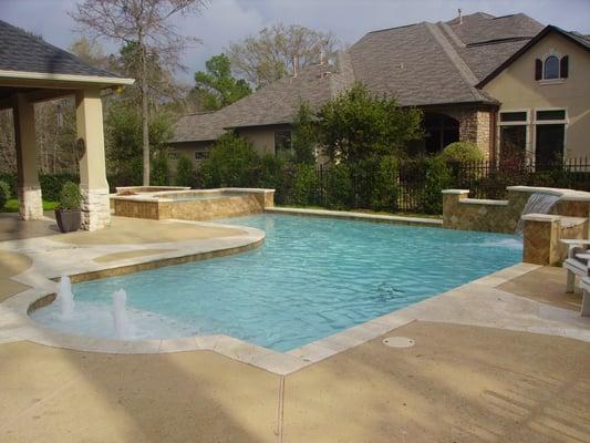 Custom pool and spa with waterfall and fire pit.