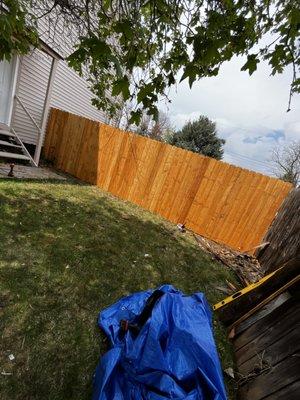 80 linear ft of wooden fence with a gate.