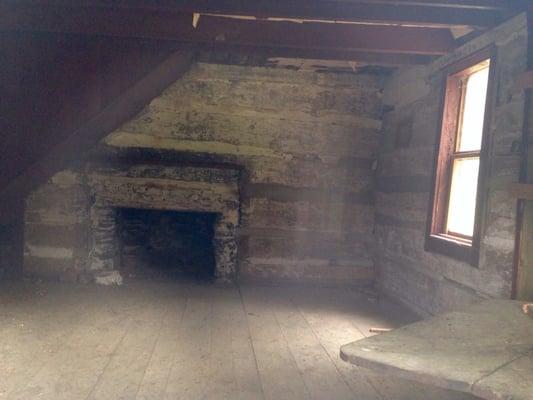 Stairwell to the left, stone fireplace in the center