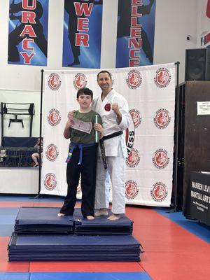 Promotion to blue belt with certificate and Shihan Warren