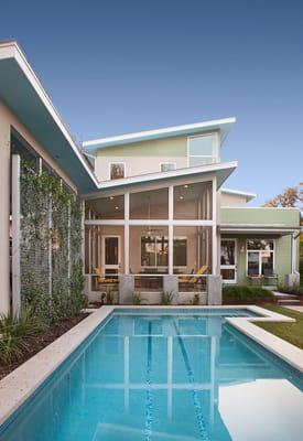 Courtyard at entry to house with screened porch facing pool.