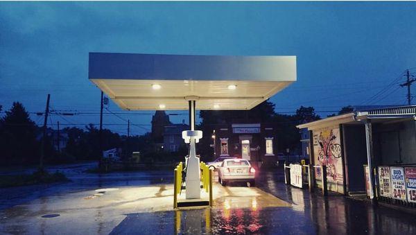 A view from the parking lot on a rainy night. The store has 4 pumps, and carries Unleaded & Diesel fuel.