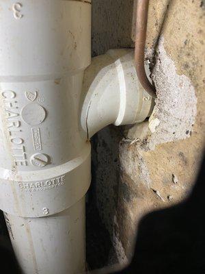 Drainage leak was found coming from a cracked PVC fitting.