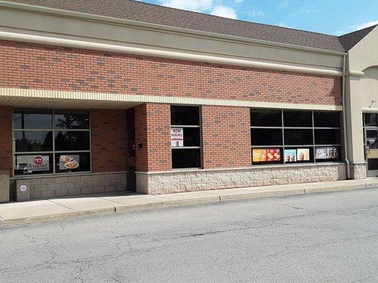 Two entrances. One on the right, and one on the left, near the "Now hiring" sign.