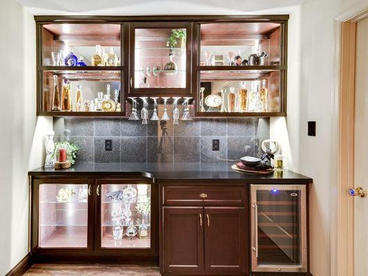 This mini bar is elegantly backlit and sits opposite a home theater, perfect for entertaining!