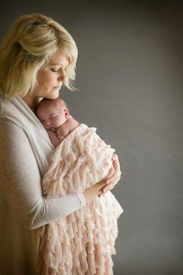 New mom embracing her baby girl during her newborn session in Denver, CO.