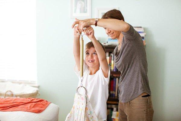 Midwifery is woman- and family-centered.  Big brother weighs his new sister.