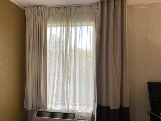 Darkening curtains and heat/AC unit.