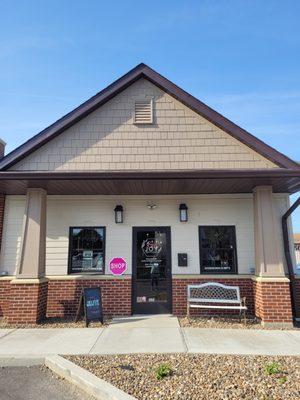 The exterior of our shop on a warm spring day. Come take a seat on our bench and enjoy the sun!