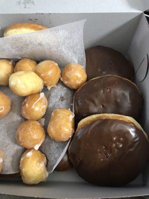 Under the parchment is a maple bar and a chocolate bar.