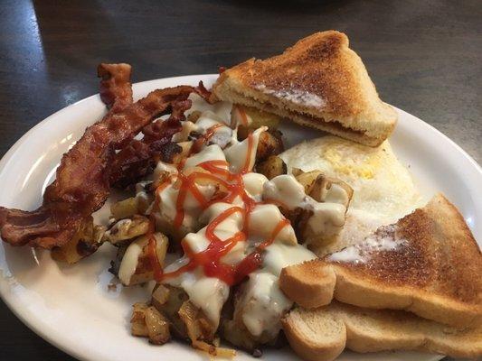 Two eggs over medium, homefries w. Cheese, bacon, and toast