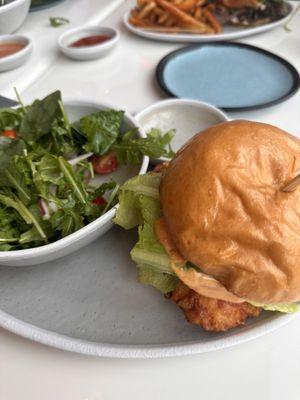 Fried chicken on brioche with a garden salad.