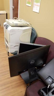 Old computer equipment stored on the hallway.