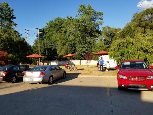 2020-07-13. Screamers Ice Cream, Sterling Heights, MI. Rear Parking lot with seating beyond.