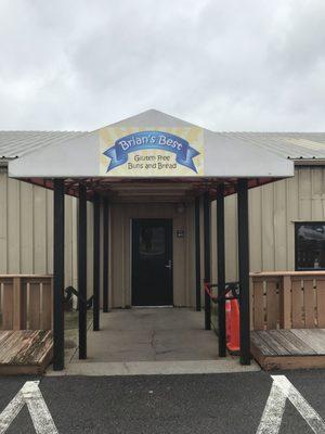 Turn right after you pass the building, then drive down the parking lot a few store fronts until you see the awning