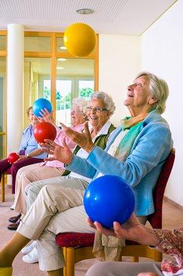 "Lively group of ladies exercising and having a blast at Senior Day KC in Lenexa, KS. Fitness and fun go hand in hand here!"