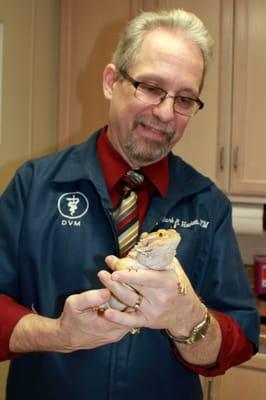 Dr. Mark Hackett examining "Hobbs," a bearded dragon