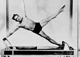 Joseph H. Pilates demonstrating the Star on the reformer.