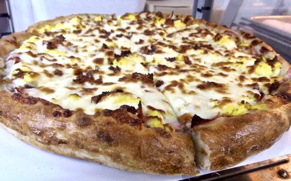 We make pizzas fresh everyday. Pictured here is our popular breakfast pizza.