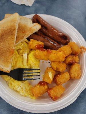 2 scrambled eggs, smoke sausage, tater tots, toast.