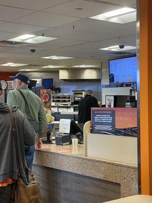 Only staff member behind the counter at an airport location! Failure on management.