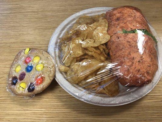 A M&M cookie for dessert and a Cajun turkey Club Wrap with kettle chips.