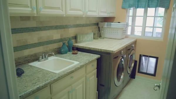 Pinnacle Tile installed tumbled travertine subway tiles with turquoise glass mosaic accent as laundry room backsplash. I love it!