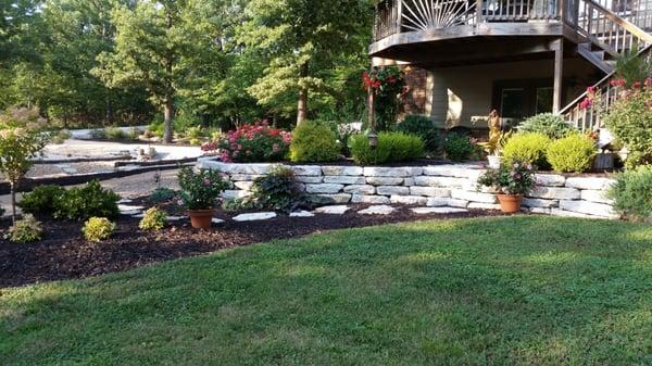 Natural stone walls with plantings that provide color all year long.