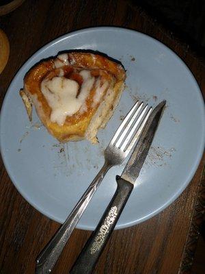 Eating a Cinnamon Roll.