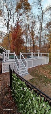 New Trex decking, contemporary railings and vinyl white lattice around pool deck.