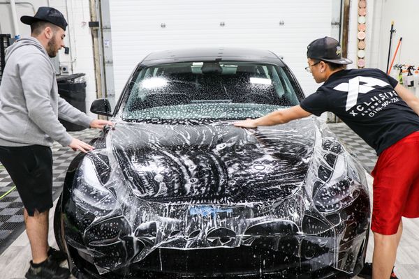 The team installing clear bra paint protection film