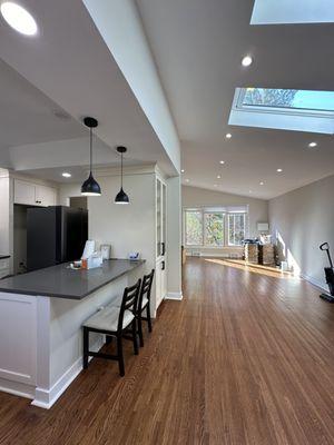 Kitchen countertop and pantry and pendant lights.