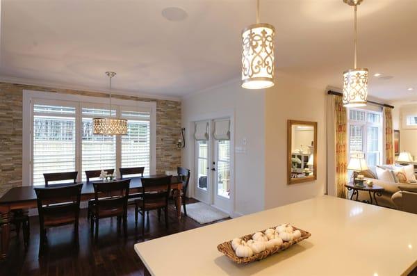 Use multiple types of window coverings to define your spaces. Here we used wooden blinds, roman shades, and curtains to define the room.