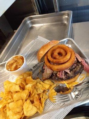 The Back Road Burger - 1/2 lb burger topped with brisket or pulled pork, onion rings, and choice of queso or American or cheddar cheese