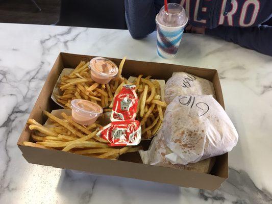 To go box with 3 burgers and 3 fries. Raspberry shake.