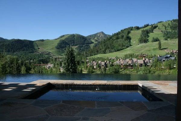 Custom swimming pool with radius infinity edge and raised therapy spa - Private Residence - Aspen, CO