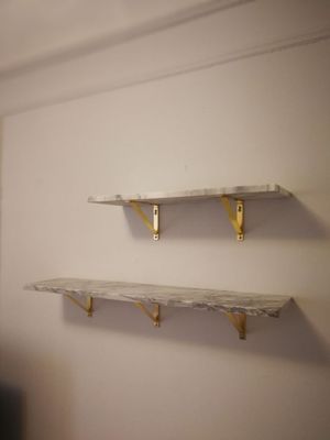 CB2 Marble Shelf Installation on plaster wall.