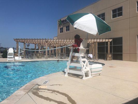 Outdoor seating, the other side of the pool, the lifeguard