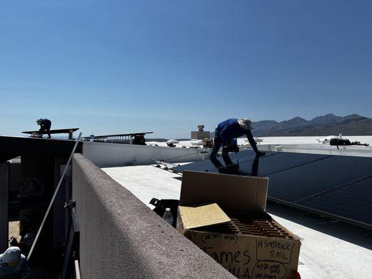 Solar panel Installation on flat roof with a tilt giving the panels the most exposure to the sun.