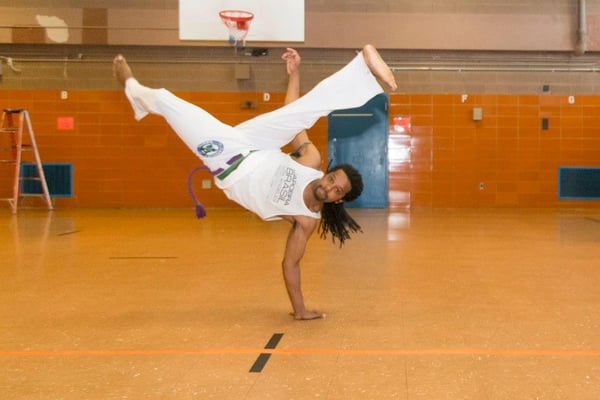 Professor Tuzinho applying Beija-Flor a capoeira unique move.