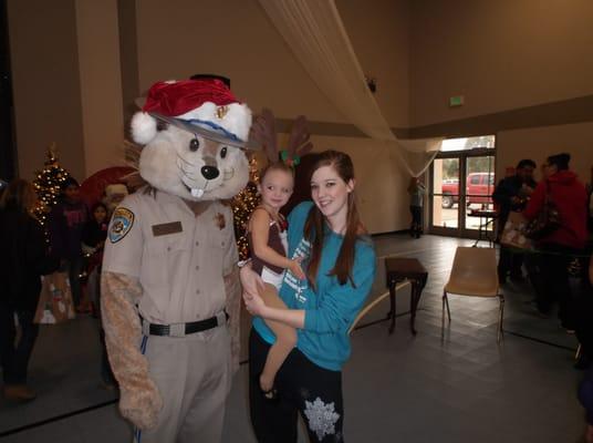 Instructor, Katie Lindsey and student, Anistin Milton pose with Chipper the CHP mascot at the Children's Christmas Festival 2014