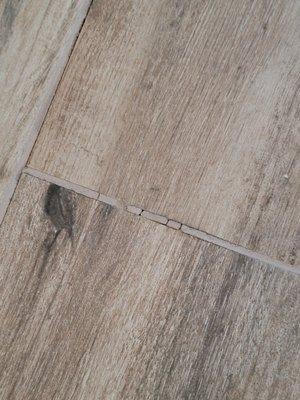 Grout cracking everywhere. Tile coming loose and making  popping sounds.