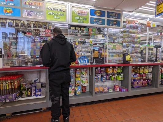 Inside the Food Mart convenience store. Waiting in line. Thanks to Zoheb (sp?) and his coworker.