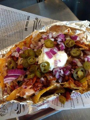 Memphis Nachos - tortilla chips (or fries or tater tots), queso, pork or chicken, jalapeños, onions, and sour cream